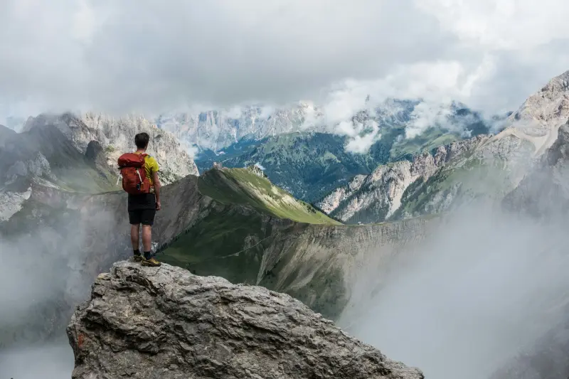 Climber standing above the clouds